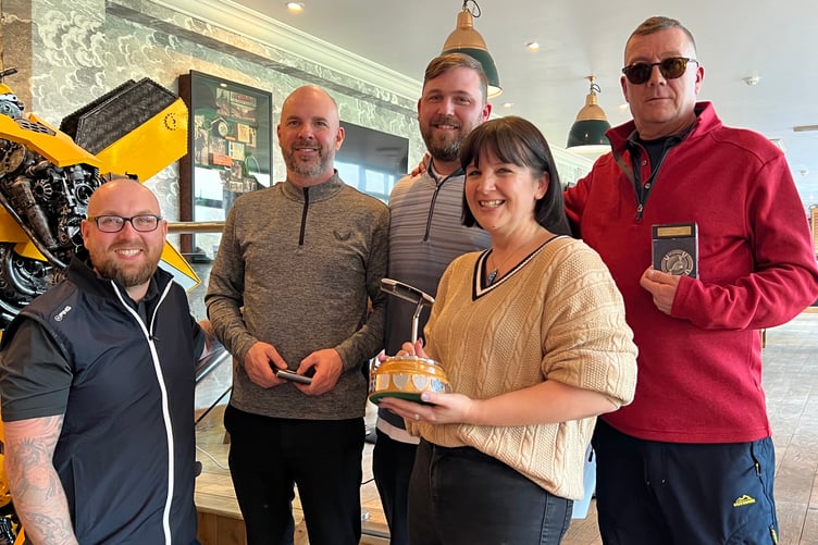 The winning team receive the trophy from Lisa Stephenson