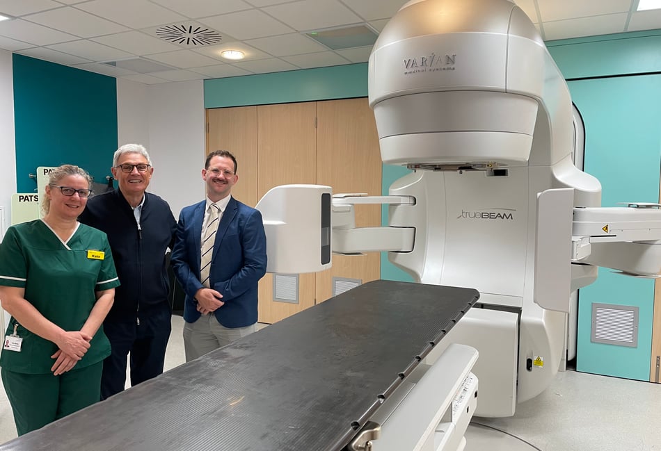 <p>Michael Robson, who is the first patient to have the prostate cancer treatment being trialled at the Royal Surrey, centre, with radiographer Kate Maltby and Dr Philip Turner, Consultant Clinical Oncologist </p>