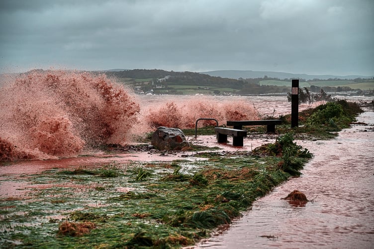 Waves coloured reddish-brown by mud batter the Steam Coast Trail between Dunster and Blue Anchor.