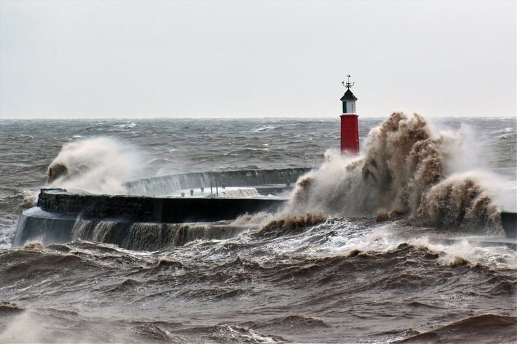 The lighthouse in Watchet Harbour stands above, just, this week's stormy sea.