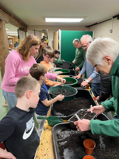 Volunteers and children participating in the workshop activities.