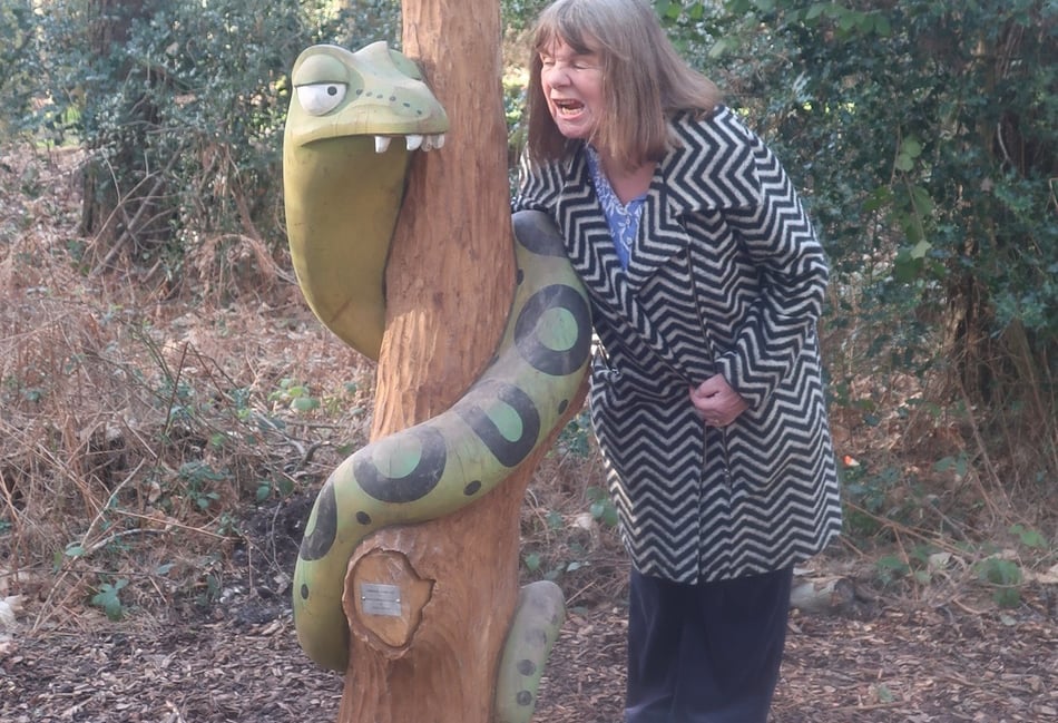 <p>Julia Donaldson, author of The Gruffalo, gets acquainted with Snake – one of four new Gruffalo sculptures unveiled in Alice Holt Forest</p>