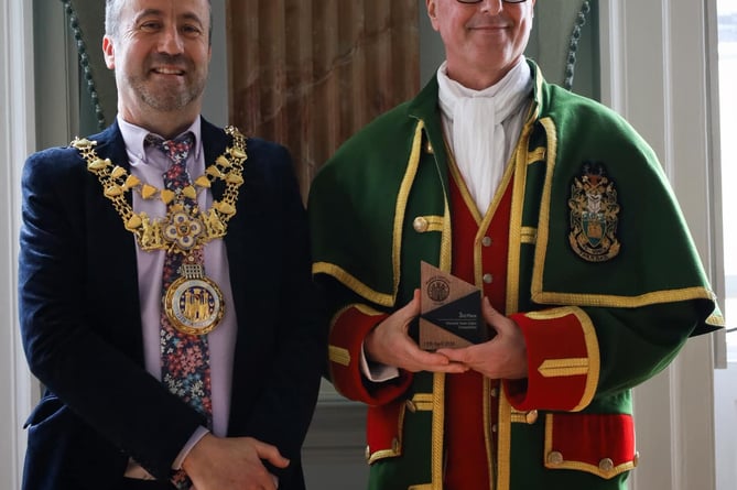 Farnham Town Crier Michael Stephens collects his awards from the Mayor of Warwick Cllr Oliver Jaques.