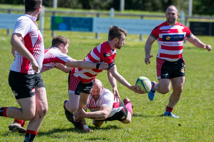Ryan Mace looks to offload in the tackle.