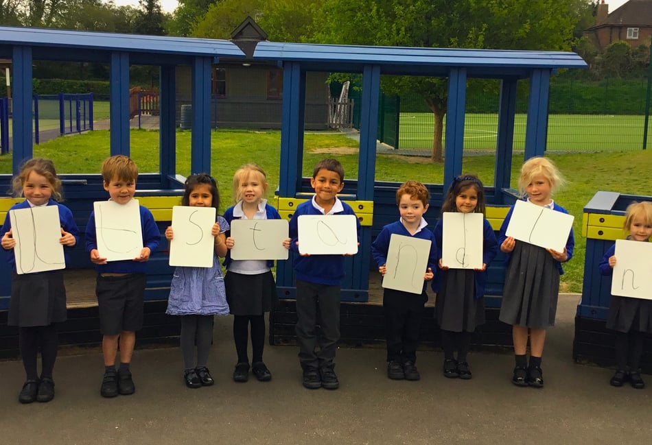 <p>Pupils at Highfield South Farnham celebrate their school's latest 'outstanding' Ofsted rating</p>