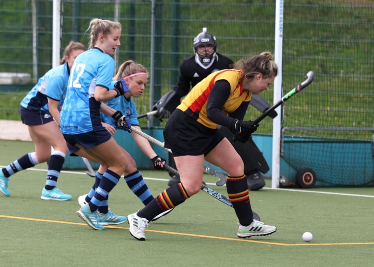 Caradon's Jules Butterworth (yellow) looks to find an angle to get a shot away.