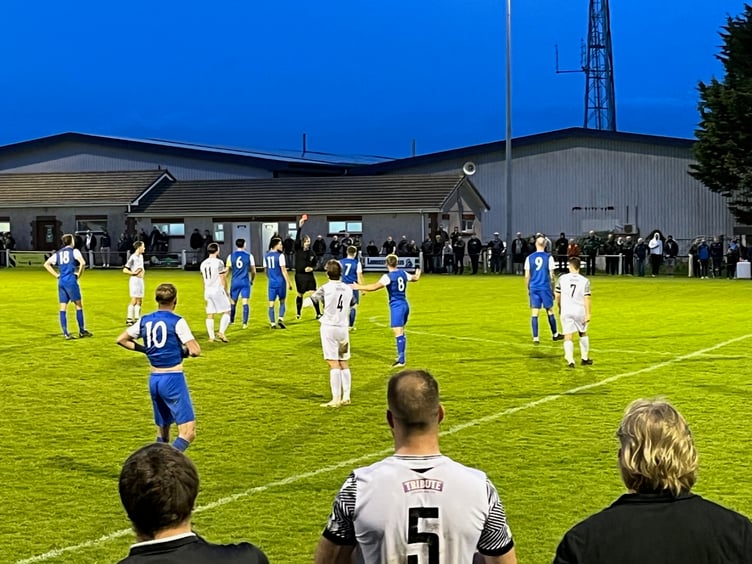 Referee Robert Fleetham brandishes a red card to Cal Merrin as Ollie Brokenshire prepares to re-enter the pitch.