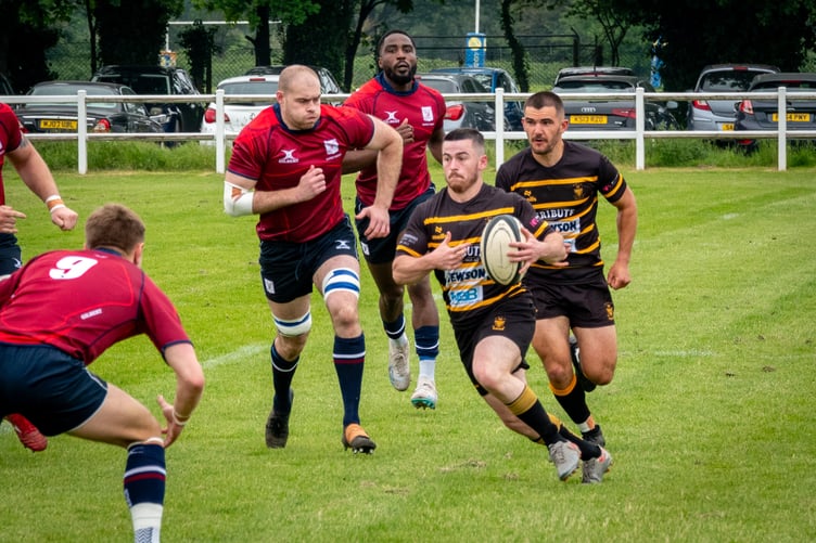 St Austell winger Dan Tyrrell runs at the Surrey defence with team-mate and scrum-half CJ Boyce in support.