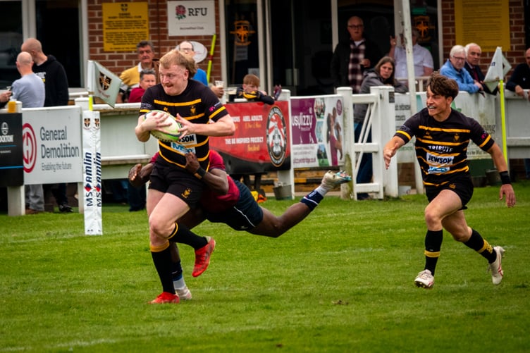 Launceston's replacement centre Cam Fogden looks to make ground with Camborne full-back Harry Larkins in support.