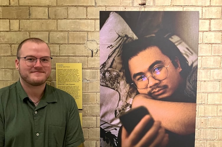 Michael Togher-Prescott in front of his portrait