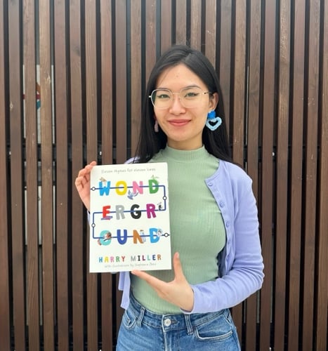 Stephanie holding a copy of Wonderground, which her drawings are featured in 