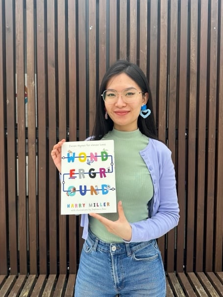 Stephanie holding a copy of Wonderground, which her drawings are featured in 