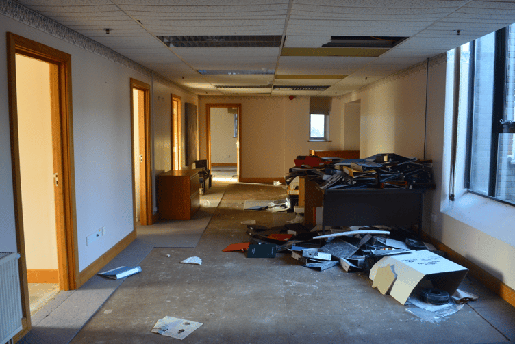 Folders are left strewn across the floor, ceiling panels slowly degraded with time and pipes left to burst or rot