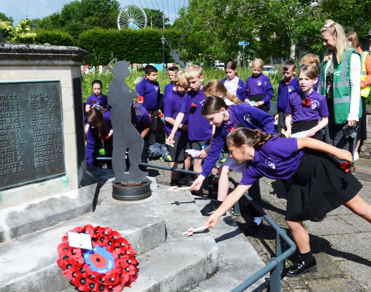 School children lay crosses on the Radstock Memorial (Photo: Will Nicol)