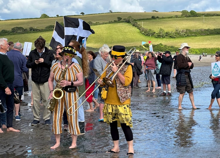 Musicians playing on the shoreline as part of the beach protest.