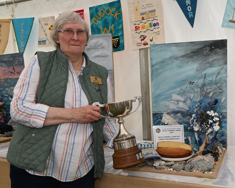 Jane Dover, Women's Institute county vice-chair, is pictured with the winning display created by the members of Ladock WI. She explained that all groups were asked to create a display based on the poem 'Sea Fever' by John Masefield. Each group had to incorporate a painted backdrop, a 'Lemon Sand Cake', a hand knitted hat, a floral art exhibit and a creative item using plastic. Each WI produced something completely unique, demonstrating their is no limit to their creativity. Jane added: "We were a bit worried that the painted backdrop would put people off but they have done so well! The item made from plastic found on the beach has been the real test though - and the groups have come up with some really unique ideas."