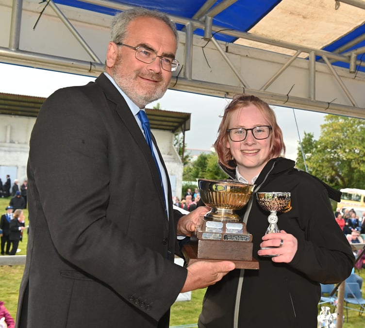 Festival president Geraint Richards presents the John Hambly Memorial Trophy for the best cornet player in the youth section to Violet Margetts of St Austell. Picture: Adrian Jasper