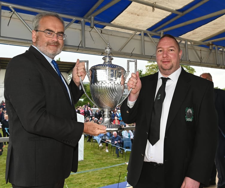 Festival president Geraint Richards presents the Ford Knight Memorial Trophy to Richard Hawkey of Roche Brass Band. Picture: Adrian Jasper