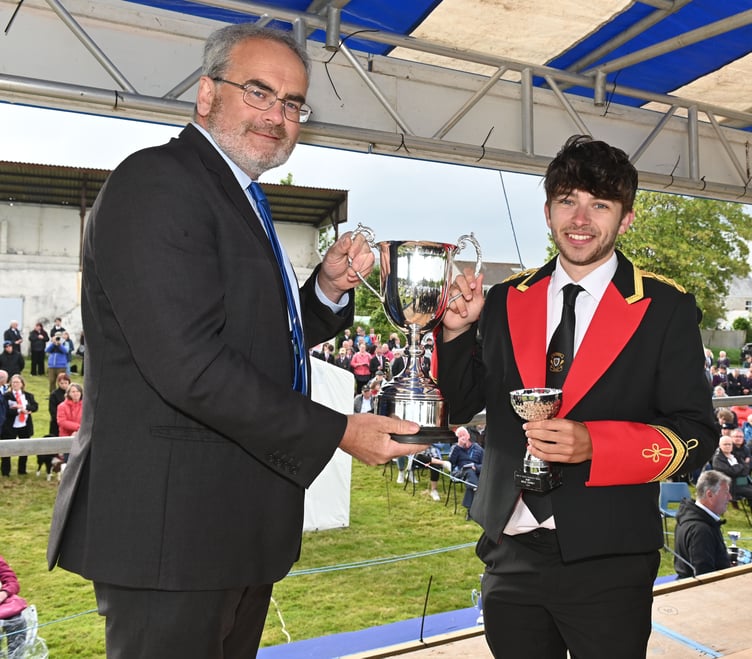 Festival president Geraint Richards presents the best player award in the championship section to Luke Barker of Camborne. Picture: Adrian Jasper