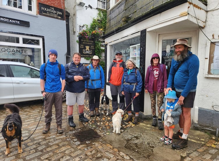 The walkers set off from the centre of Mevagissey in wet weather.