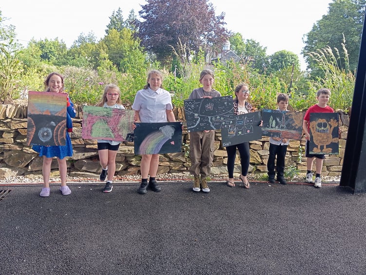 Pavement artists show off their designs. (Picture: Liskeard Lions)
