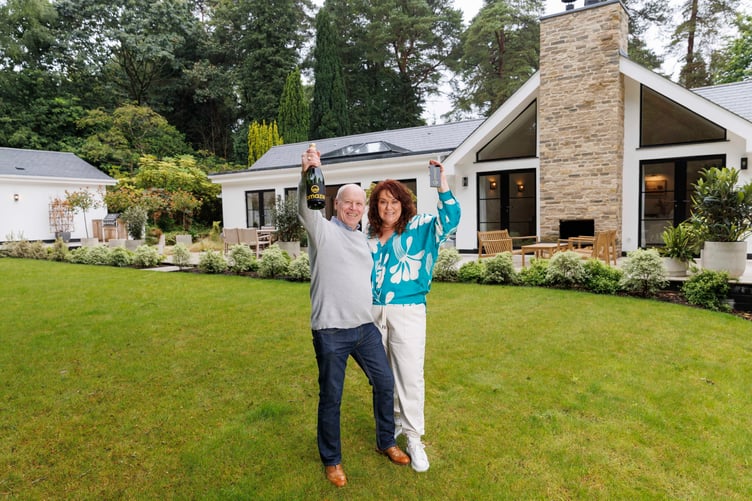 Rachael and husband Darren outside their new £3 million house near Farnham