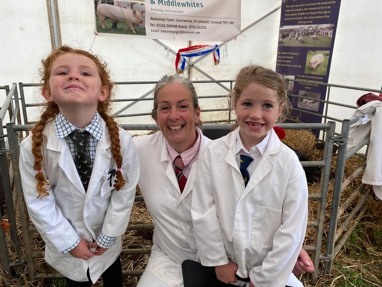 Pig breeder Caroline Dunstan with the next generation of handlers, Delilah and Florence, both six