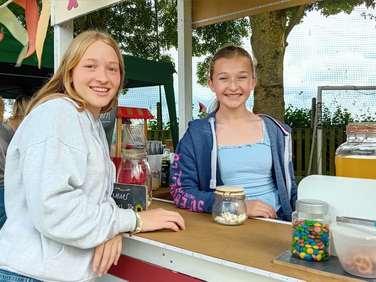 Fenna McGuire, left, chats to Fitzhead fete popcorn stall holder Connie Burton, aged 12. PHOTO: Sue Mitchison.