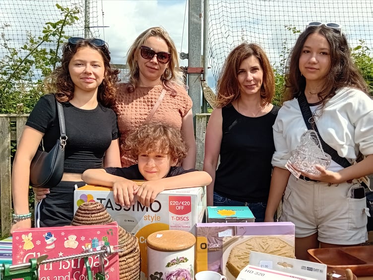 Ukrainian visitors browsing through the bric a brac stall at Fitzhead fete, left to right, Ksusha Kahal, Tanya Wyshneva, Tanya Gonchar, Anya Salo, with Andrey Salo (centre). PHOTO: Sue Mitchison.