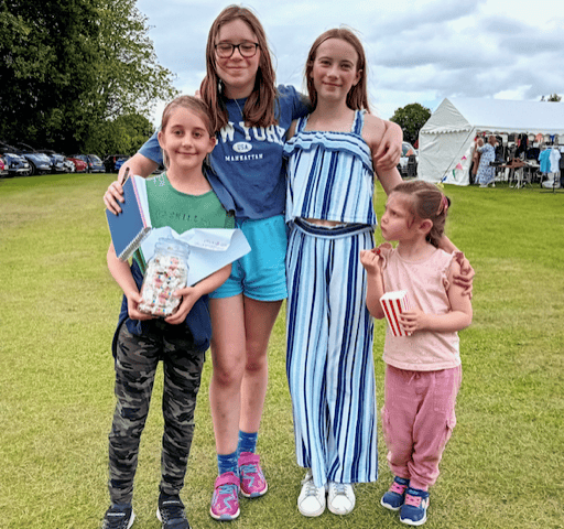 How many sweets in that jar? Enjoying Fitzhead fete, left to right, were Beth Tout, 8, Daisy Brewerton, 12, Megan Sully, 12, and Ginny Sully, 4. PHOTO: Sue Mitchison