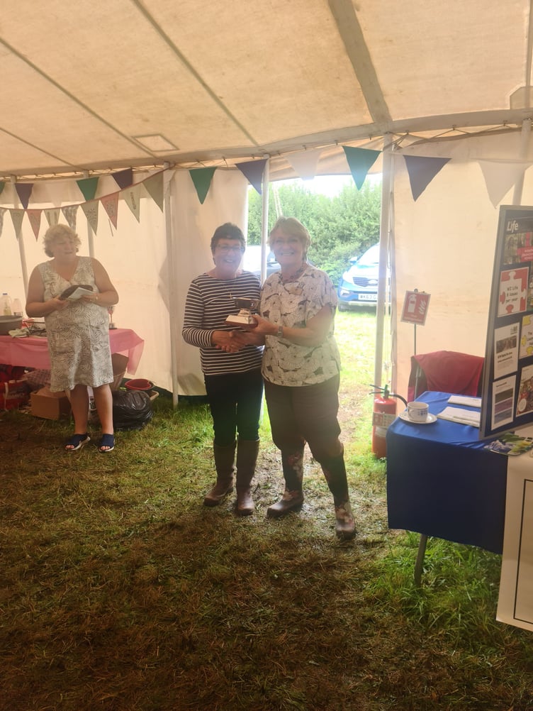 Altarnun WI's Gilly Crossley receiving the cup for Best Craft from CFWI vice chair Pam Selley
