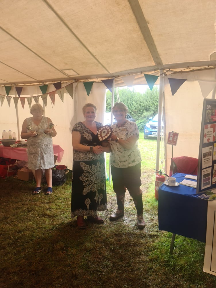 Helen Naylor of Altarnun WI picked up the cup for Best Floral and went on to collect the shield for Overall Points