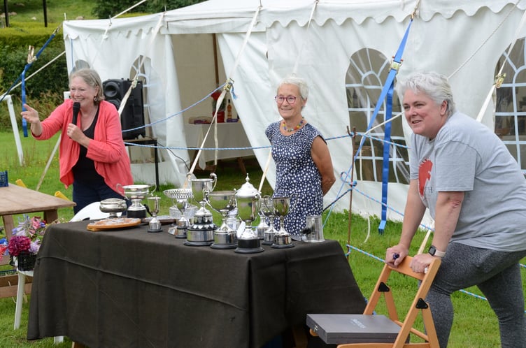 Claire Rawle takes bids in an auction of produce and flowers at the summer Bicknoller Flower Show.