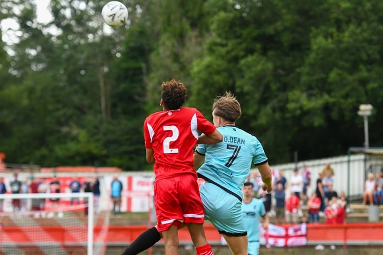 Farnham Town's Owen Dean competes for a header