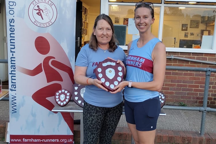 Overall and senior ladies' winner Lizzie May receives her trophy from Nicola O'Connor