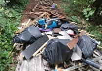 Asbestos and building waste dumped by fly-tippers on Farnham path