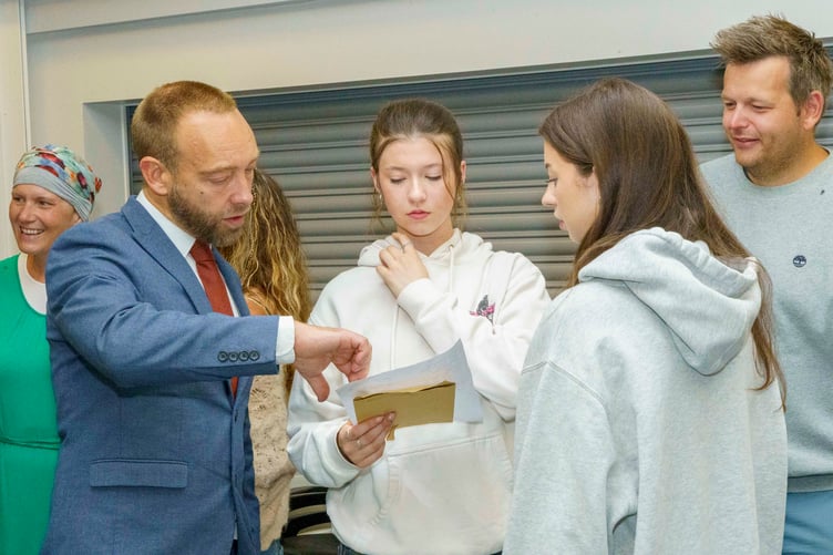 Roseland Academy headteacher Richard Clarke reads results with students