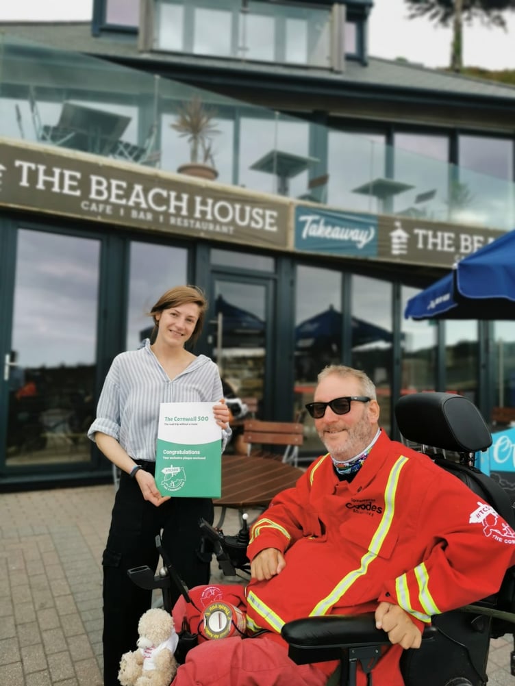 Steven Webb drops a Cornwall 500 plaque into The Beach House in Seaton