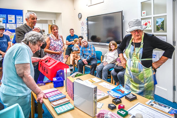 Jenny Ellacott choosing her raffle prize. Picture: Derek Williams