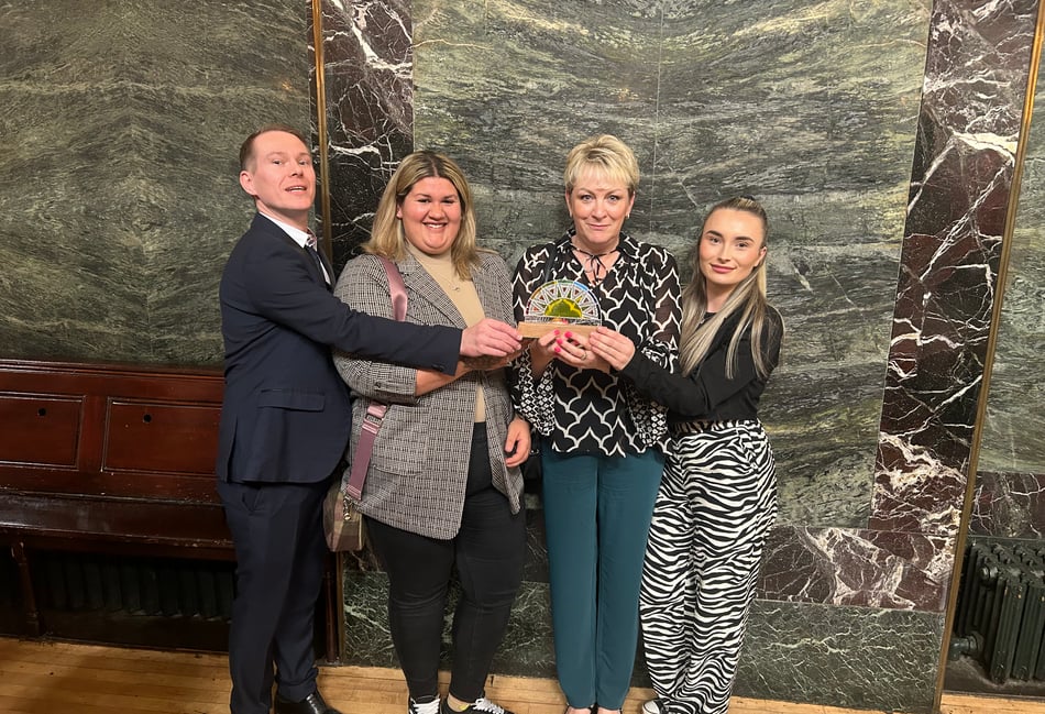 <p>The team celebrate the home's achievement (Langham Court)</p>