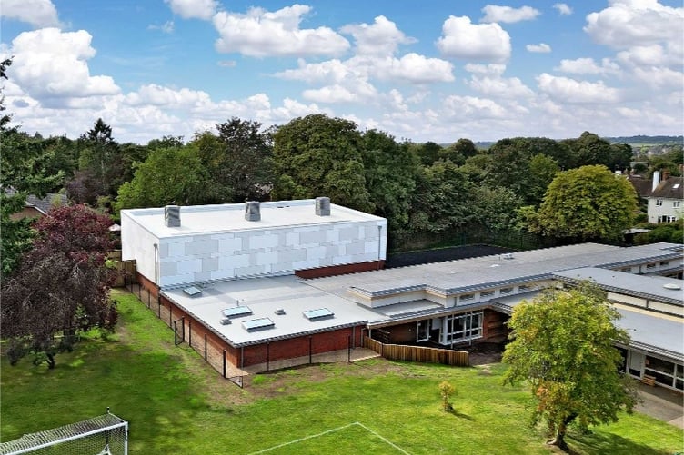 The new sports hall, changing rooms and teaching block extension, linking to the existing school building at The Abbey School in Farnham