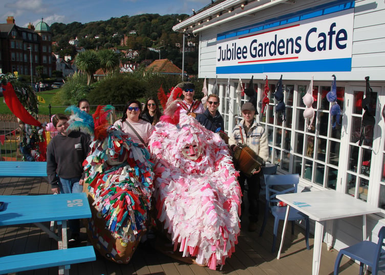 Customers of the Jubilee Cafe, Minehead, meet the town's traditional hobby horse during a charity fund-raising weekend. PHOTO:George Ody.