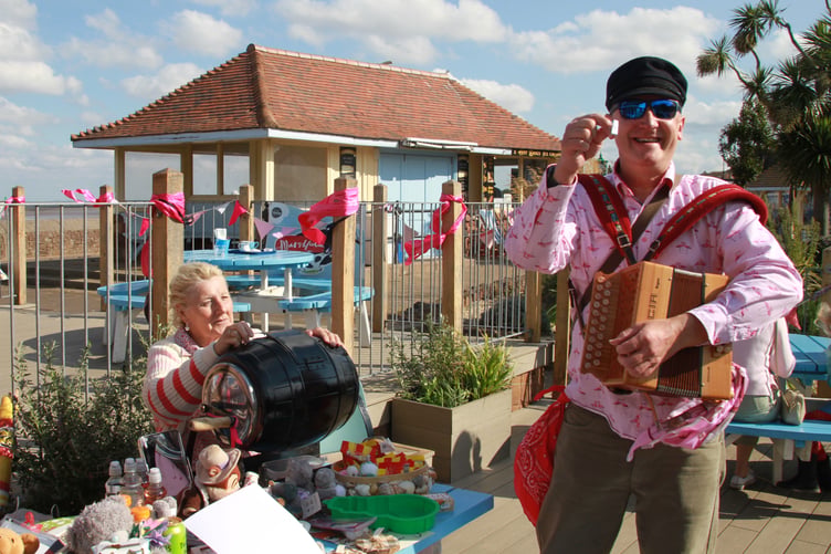 Mark James celebrates a winning tombola ticket at Minehead Jubilee cafe's 'Wear It Pink' weekend. PHOTO: George Ody.