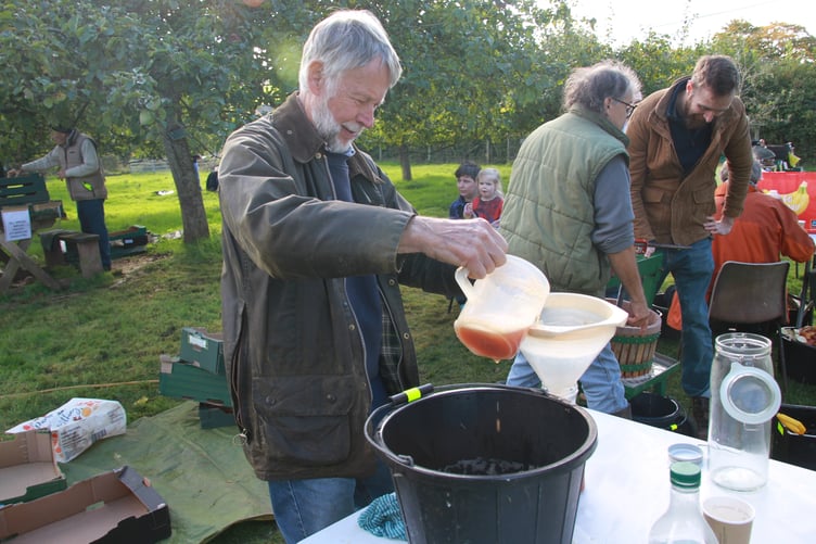 Apple juice being bottled during Carhampton Apple Day by Stuart Heesom. PHOTO: George Ody.