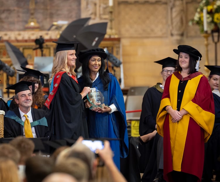 Poppy Budden receives her award from Dr Beverly Joshua