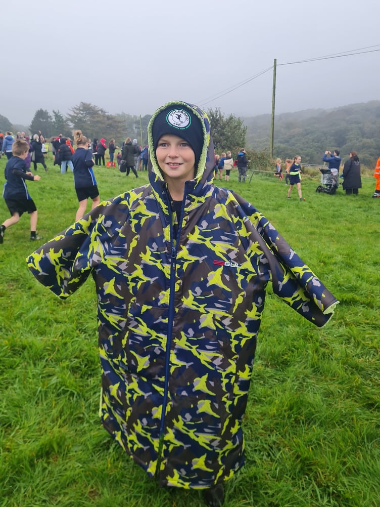 Wrapping up warm after a well run race is a Polperro Primary Academy team member