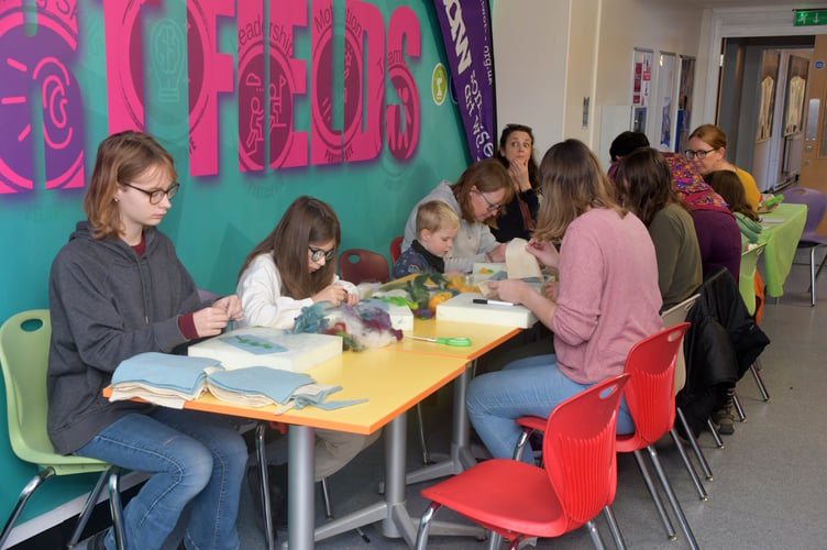 Visitors to the Wellington Together event ry their hands at crafting.