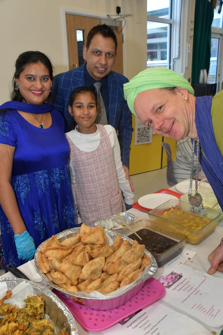 Hanna, Kashan, and Kakab explain their food to Indian dancer Leryn Blackburn at Wellington Together.