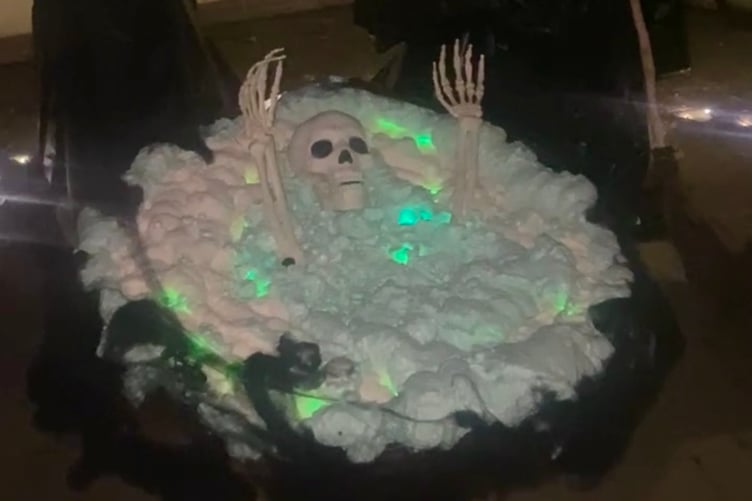 Witches cooking cauldron with a lost soul stuck inside