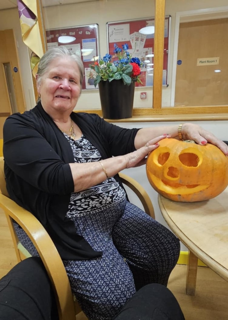 Patricia Hill with her carved Halloween pumpkin in Camelot House and Lodge.